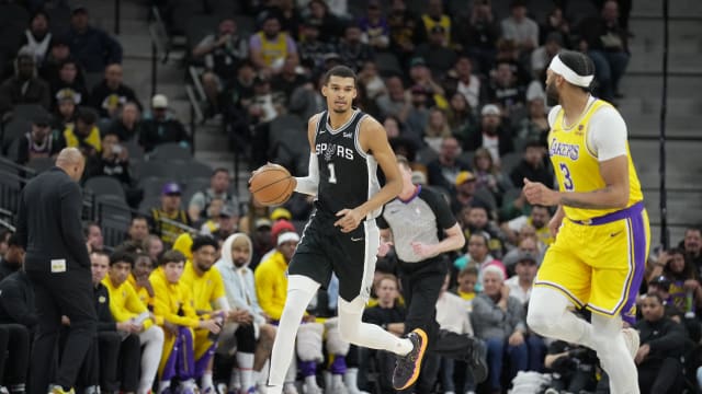Dec 13, 2023; San Antonio, Texas, USA; San Antonio Spurs center Victor Wembanyama (1) dribbles the ball in front of Los Angeles Lakers forward Anthony Davis (3) in the first quarter at the Frost Bank Center.